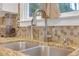 Close up of the stainless sink with granite countertop and modern style faucet at 3310 Vista Creek Dr, Dacula, GA 30019