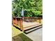 Inviting backyard deck with seating surrounded by lush greenery, ideal for relaxation and entertaining in a serene outdoor setting at 5848 Rex Ridge Loop, Rex, GA 30273
