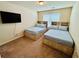 Comfortable bedroom with two beds, built-in storage, and a mounted TV at 5848 Rex Ridge Loop, Rex, GA 30273