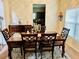 Elegant dining room with wooden table, seating for six, and stylish decor accents at 5848 Rex Ridge Loop, Rex, GA 30273
