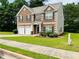 Charming two-story brick home with well-manicured lawn and a two-car garage at 5848 Rex Ridge Loop, Rex, GA 30273
