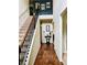 Inviting foyer with hardwood floors, staircase, and decorative accents creating a warm welcome at 5848 Rex Ridge Loop, Rex, GA 30273