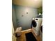 Well organized laundry room with large washer dryer and decorative shelf at 5848 Rex Ridge Loop, Rex, GA 30273