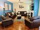 Cozy living room features leather seating, wood floors, and a Relax sign above the sofas at 5848 Rex Ridge Loop, Rex, GA 30273