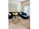Stylish living room featuring a comfortable black sectional, modern glass coffee table, and chic decor at 5848 Rex Ridge Loop, Rex, GA 30273