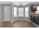 Charming dining area with bright windows, chandelier, and wood-look floors at 2505 Se Tiffany Ct, Conyers, GA 30013