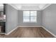 Dining area boasting a tray ceiling, a bright window, and wood-look floors at 2505 Se Tiffany Ct, Conyers, GA 30013