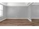 Bright dining area with gray walls, wood-look floors, and tray ceiling at 2505 Se Tiffany Ct, Conyers, GA 30013