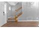The entryway showcases hardwood floors and a staircase with carpeted steps and white railings at 2505 Se Tiffany Ct, Conyers, GA 30013
