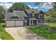 Charming two-story home with a well-manicured lawn, a two-car garage, and a welcoming front porch at 2505 Se Tiffany Ct, Conyers, GA 30013