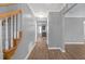 Inviting hallway with wood-look floors, gray walls, and staircase leading to the upper level at 2505 Se Tiffany Ct, Conyers, GA 30013