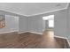Spacious living room with wood-look floors, neutral gray walls and staircase at 2505 Se Tiffany Ct, Conyers, GA 30013