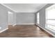 Bright living room featuring wood-look floors, large windows, and neutral gray walls at 2505 Se Tiffany Ct, Conyers, GA 30013