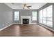 Bright living room featuring a fireplace, wood floors, neutral paint, and lots of natural light at 2505 Se Tiffany Ct, Conyers, GA 30013