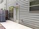 Exterior shot of backyard with a small patio, windows, and wood siding at 2508 Norwood Park Xing, Atlanta, GA 30340