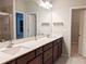 Bathroom featuring double vanity with white countertops and dark wood cabinets at 2508 Norwood Park Xing, Atlanta, GA 30340