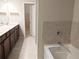 Primary bathroom showcasing double vanity, dark wood cabinets, and a separate tub and shower at 2508 Norwood Park Xing, Atlanta, GA 30340