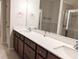 Primary bathroom featuring double vanity with white countertops and dark wood cabinets at 2508 Norwood Park Xing, Atlanta, GA 30340