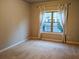 Comfortable carpeted bedroom with a large window offering a view of the neighborhood at 2508 Norwood Park Xing, Atlanta, GA 30340