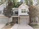 Charming townhome with brick accents, neutral siding, a well-manicured lawn and an attached one car garage at 2508 Norwood Park Xing, Atlanta, GA 30340