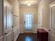 Bright foyer with neutral walls, wainscoting, and dark hardwood floors, complemented by modern lighting at 2508 Norwood Park Xing, Atlanta, GA 30340