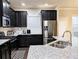 Modern kitchen with black cabinets, stainless steel appliances, granite countertops, and subway tile backsplash at 2508 Norwood Park Xing, Atlanta, GA 30340