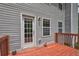 Back Deck with weathered wood, grey siding, and a door with multiple window panes at 347 Cobblestone Court, Hampton, GA 30228