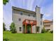 View of the home's rear, showcasing a cozy deck overlooking the manicured lawn at 347 Cobblestone Court, Hampton, GA 30228