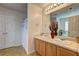 Bright bathroom featuring double vanities, a full mirror, and tile flooring at 347 Cobblestone Court, Hampton, GA 30228