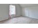 Bedroom features neutral carpet, a window, and bright natural lighting at 347 Cobblestone Court, Hampton, GA 30228