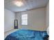 Cozy bedroom featuring neutral walls, a bed with a blue coverlet, and a window at 347 Cobblestone Court, Hampton, GA 30228