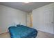 Comfortable bedroom featuring neutral walls, a bed with a blue coverlet, and a closet at 347 Cobblestone Court, Hampton, GA 30228