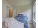 Bedroom featuring carpet, floral print comforter, and bright natural lighting at 347 Cobblestone Court, Hampton, GA 30228