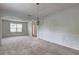 Formal dining room boasts elegant wainscoting, a chandelier, and neutral carpet with great natural light at 347 Cobblestone Court, Hampton, GA 30228