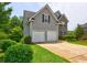 Two story home featuring gray siding, stone accents and two car garage at 347 Cobblestone Court, Hampton, GA 30228