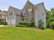 Well-maintained home with a lush lawn, tidy shrubbery, and neutral colored siding with black shutters at 347 Cobblestone Court, Hampton, GA 30228