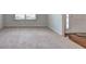 Welcoming living space with wood floors, neutral carpet, a large window, and a bright front door at 347 Cobblestone Court, Hampton, GA 30228