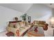 Cozy living room with vaulted ceiling, comfortable seating, and natural light at 347 Cobblestone Court, Hampton, GA 30228