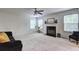 Bright living room featuring a fireplace, large windows, and comfortable seating at 347 Cobblestone Court, Hampton, GA 30228