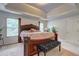 Comfortable main bedroom featuring a large bed, natural light, and a decorative tray ceiling at 347 Cobblestone Court, Hampton, GA 30228