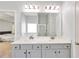 Bathroom featuring dual sinks, gray cabinets, and a large mirror at 911 Sonoma Dr, Lawrenceville, GA 30045