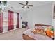 This bedroom has carpet and is brightly lit with natural light, ceiling fan, and pink curtains at 911 Sonoma Dr, Lawrenceville, GA 30045