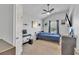 This bedroom has light carpet, TV, ceiling fan, and artwork on the walls at 911 Sonoma Dr, Lawrenceville, GA 30045