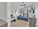 This bedroom has light carpet, TV, ceiling fan, and artwork on the walls at 911 Sonoma Dr, Lawrenceville, GA 30045
