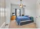 This bedroom has carpet and is brightly lit with natural light, ceiling fan, and blue curtains at 911 Sonoma Dr, Lawrenceville, GA 30045