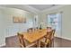 Elegant dining room features hardwood floors, wainscoting, and a wooden table perfect for entertaining at 911 Sonoma Dr, Lawrenceville, GA 30045