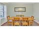 Bright dining room with a wooden table, six chairs, and a large window with natural light at 911 Sonoma Dr, Lawrenceville, GA 30045