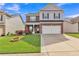 Beautiful exterior view of a two-story home with well-manicured lawn, colorful flowerbeds, and inviting curb appeal at 911 Sonoma Dr, Lawrenceville, GA 30045