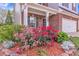 Landscaped front yard with vibrant flowerbeds, manicured shrubs, and a charming two-story brick home at 911 Sonoma Dr, Lawrenceville, GA 30045