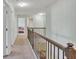 Hallway with a carpet floor and wooden railing at 911 Sonoma Dr, Lawrenceville, GA 30045